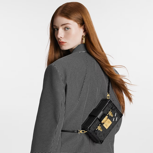 A girl wearing LV Petite Malle