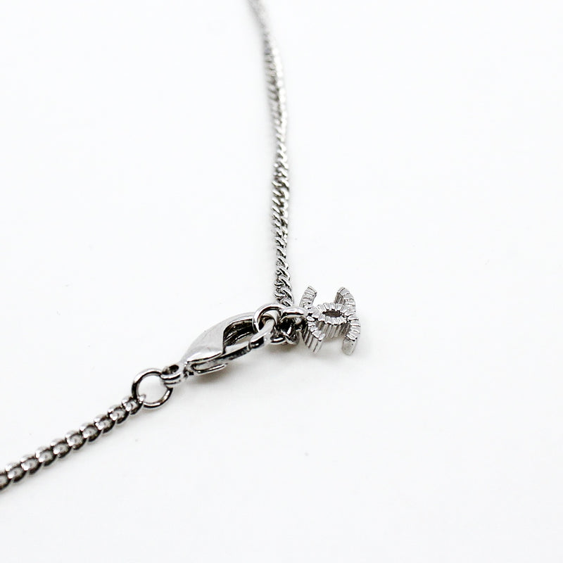 cc necklace with cc pearl logo and pearls