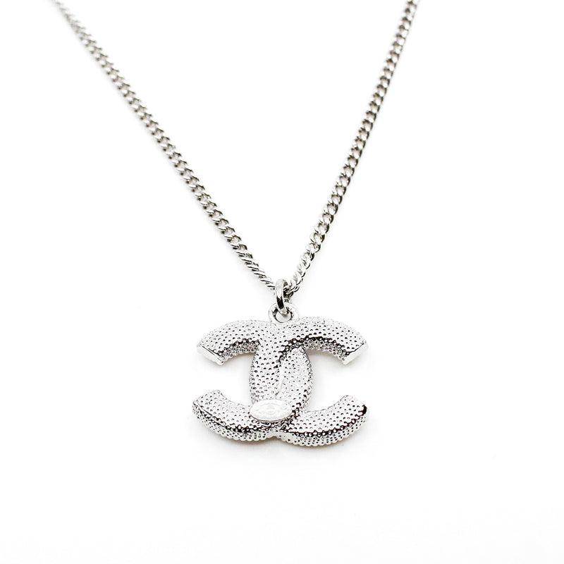 cc necklace with cc pearl logo and pearls